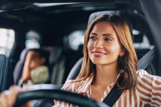 istock Mom Smiling While Driving Son to School in Morning 2169109479