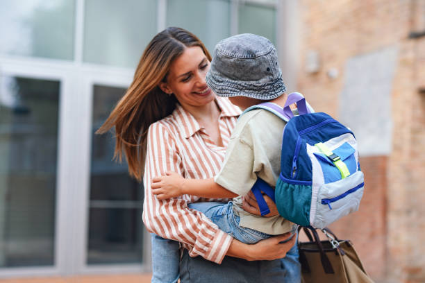 istock Mother and Son Embrace on First Day of Elementary School 2169109500