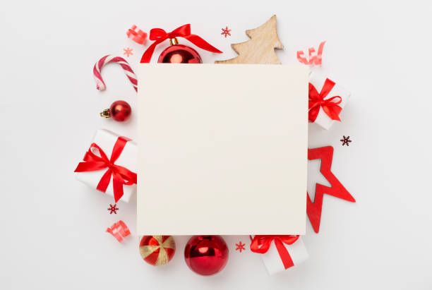 istock Greeting card mockup with christmas decor on color background, top view 2169110496