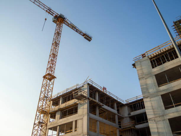istock Yellow construction crane in front of a building under construction 2169111854