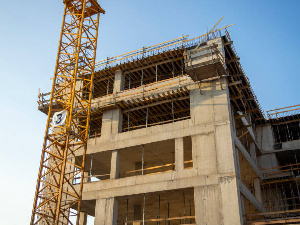 istock Yellow construction crane in front of a building under construction 2169111865