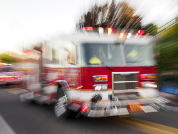 istock Fire Engine Out of Focus Emergency Lights On in Parade 2169120645