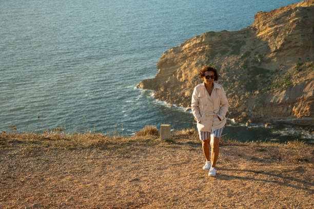istock Elderly woman walking along Cabo Espichel 2169121608