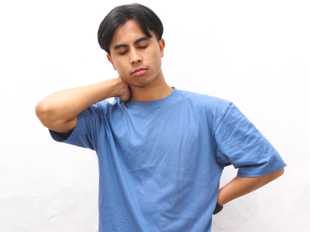 istock Stressed young Asian man wearing blue t-shirt posing on white background. 2169123805