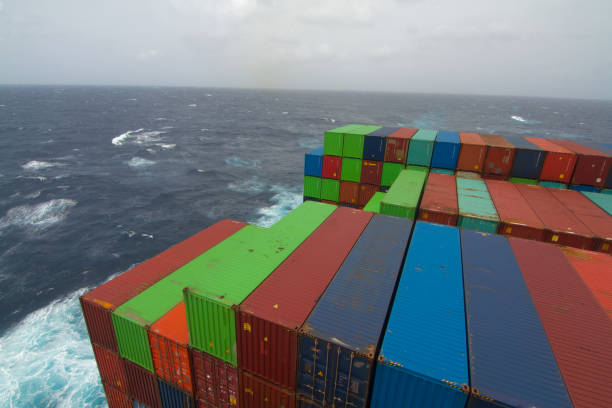 Cargo containers piled high in an international shipping yard, export, logistics, and global transportation concept.