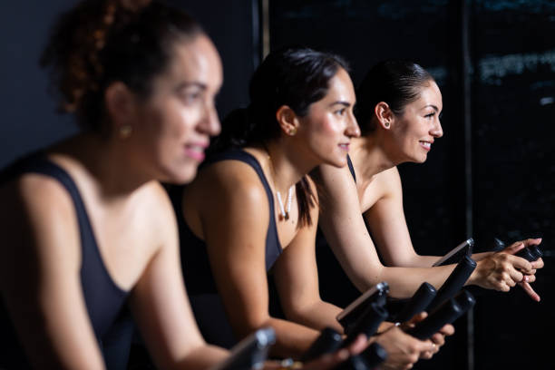 Young adult asian women engaging in a exercising class at a gym, focusing on fitness and a healthy lifestyle