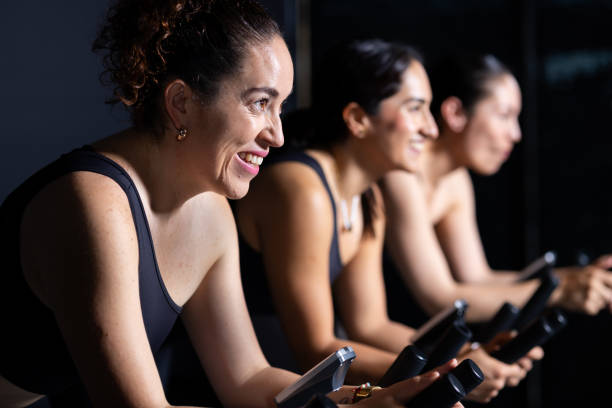 Female trainers doing indoor cycling exercise in the gym