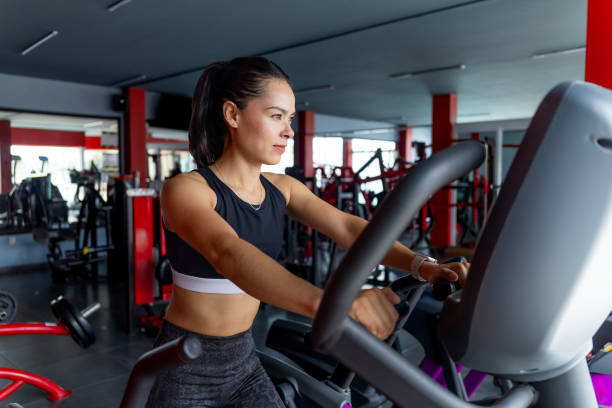istock Woman training on elliptical treadmill 2169136551