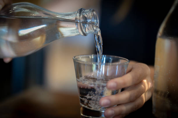 istock Pouring water into a glass at a cafe. 2169142393