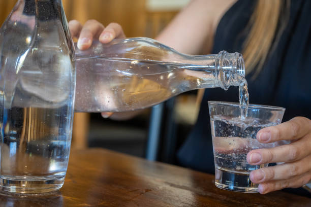 Still or sparkling water in a glass cup at a cafe.