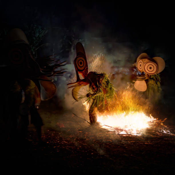 he captivating photo depicts the Baining Fire Dance performed at night. In this sacred ceremony, Baining dancers move in a state of trance, barefoot through the flames, connecting with ancestral spirits represented by the masks they wear. The dance is a powerful reminder of their close relationship with these spirits.