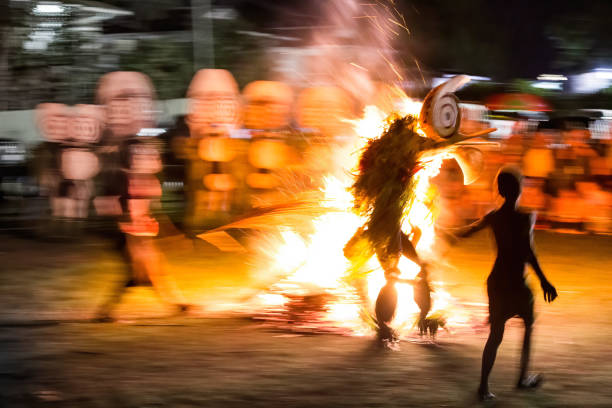he captivating photo depicts the Baining Fire Dance performed at night. In this sacred ceremony, Baining dancers move in a state of trance, barefoot through the flames, connecting with ancestral spirits represented by the masks they wear. The dance is a powerful reminder of their close relationship with these spirits.