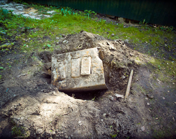 old rusty metal container dug out of the ground, outdoor shot