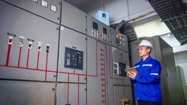 istock Electrical engineers check the operation of the main electrical control panels and switches, record values on tablets, electrician inspect the electrical systems in the factory. 2169157044