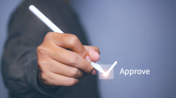 istock Businessman tick correct mark to approve document. Acceptance and quality agreement, assurance, evaluation and checklist. Checkbox correct sign. 2169161315