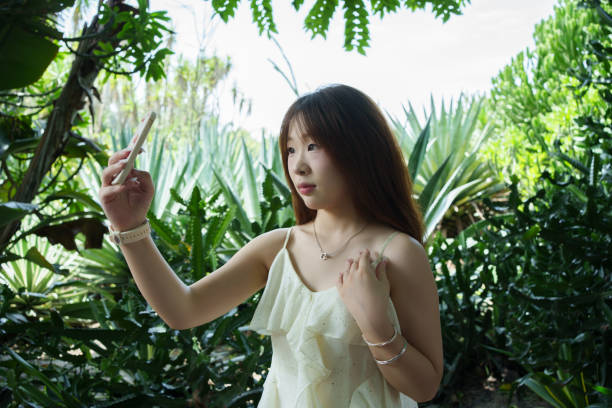 istock Young woman taking selfie with mobile phone 2169166755