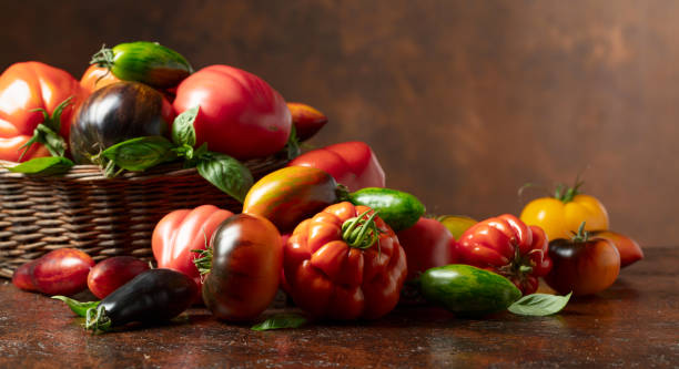 istock Different varieties of tomatoes on a brown background. 2169171794