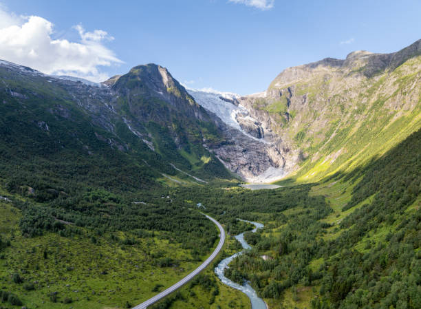 Panoramic view of a beautiful mountain river. Cascade mountain stream with rapids. Briksdal glacier hike Briksdalsbreen mountain lodge