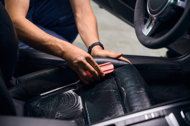istock Worker carefully cleans car seats with a brush 2169180647