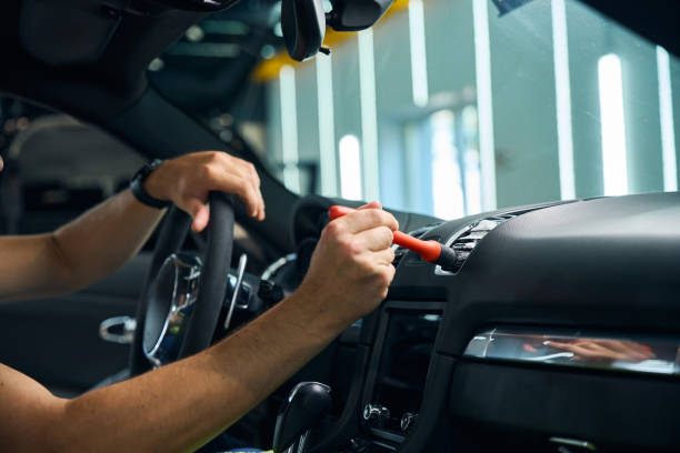 istock Guy cleans the ventilation grill inside a car 2169181774