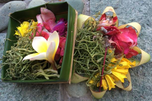Canang Sari, the Traditional balinese offerings to gods in Bali with flowers and aromatic sticks