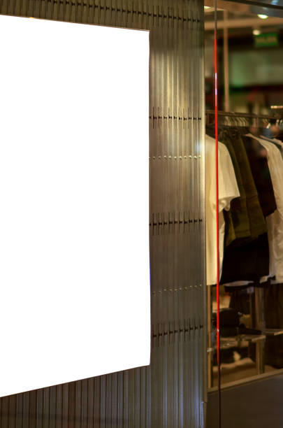 istock A white sign is hanging on a wall next to a rack of clothes. 2169183065