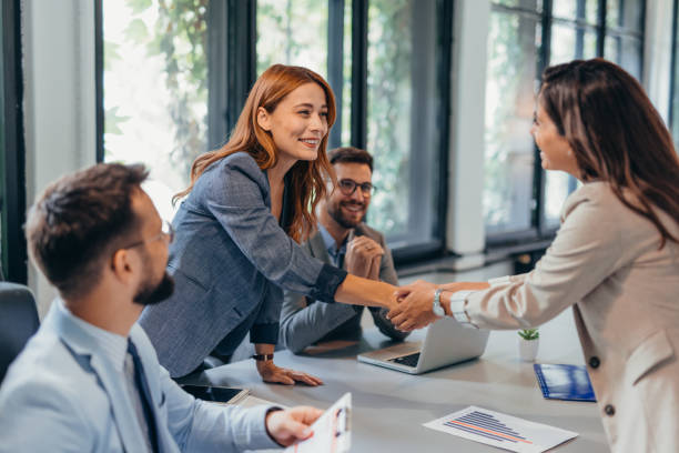 istock Business meeting handshake in modern office setting. 2169184505