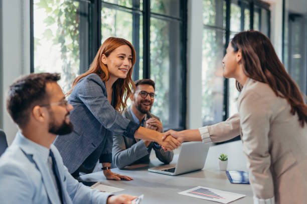 istock Business meeting handshake in modern office setting. 2169184515
