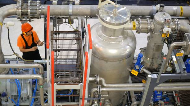 istock Technician inspects complex gas processing equipment at industrial facility. Focus is on ensuring accurate instrument readings and pipeline integrity to maintain safe and efficient operations. 2169186059