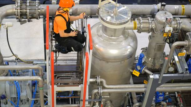 istock Maintenance specialist conducts technical inspections and preventive maintenance on production line equipment. Key tasks involve maintaining high productivity and preventing downtime. compressor 2169186201