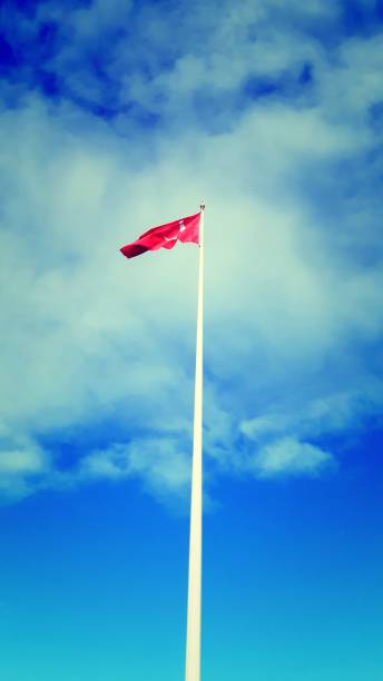 istock The red Turkey flag flying in the blue sky 2169186430