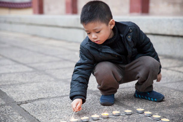 istock A Chinese little boy lights candles in a temple 2169191032