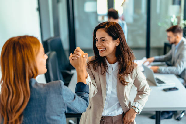 istock Two professional women celebrating success in a modern office space. 2169191672