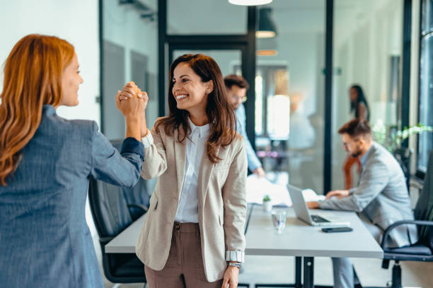 istock Two professional women celebrating success in a modern office space. 2169191674