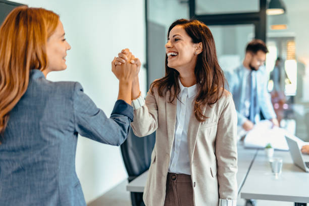 istock Two professional women celebrating success in a modern office space. 2169191677