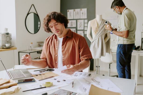 istock Designers Creating Fashionable Dress 2169191764