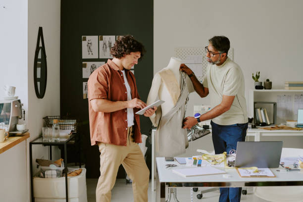 istock Designer and Tailor Working Together in Atelier 2169192142