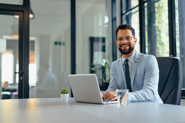 istock Happy businessman working on laptop in the office 2169193096