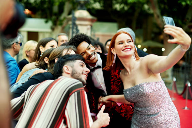 istock Fans and celebrities posing for selfie at red carpet event 2169193314