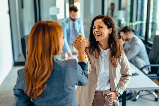 istock Two professional women celebrating success in a modern office space. 2169193578