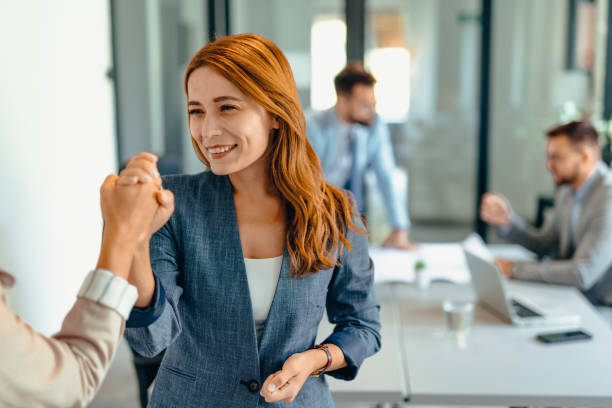 istock Two professional women celebrating success in a modern office space. 2169194072