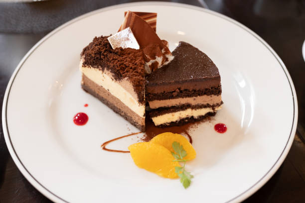 istock A slice of layered chocolate cake served with oranges. 2169195892