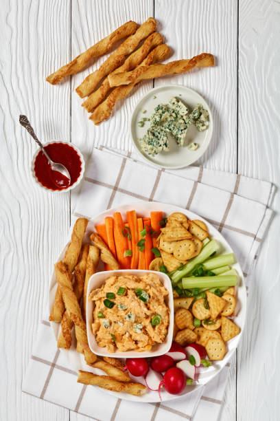 istock buffalo chicken dip with veggie and bread sticks 2169199219