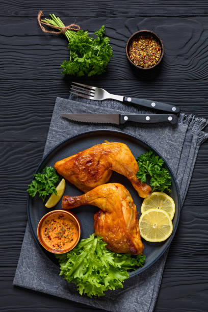 istock fried chicken legs with lettuce, lemon on plate 2169199342