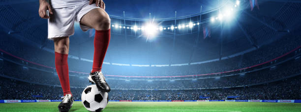 istock Soccer Player Standing with Ball in the Stadium 2169200544