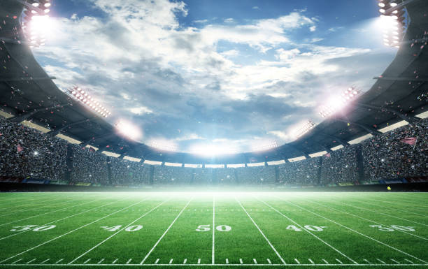 istock IIuminated American Football Stadium at night with empty field. 2169200883