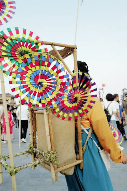 Xi’an China - August 24 2024: A large number of tourists gather on Xi'an's Yongning Gate City Wall to sightsee and take photos. Some visitors are dressed in traditional Hanfu, blending into the historical ambiance of the ancient city wall. They stroll along the wall, capturing memories that combine ancient and modern experiences. The city wall is lively, showcasing the fusion of history and culture.Captured with the Leica Q3.Thailand.