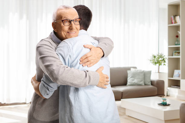 istock Elderly man hugging a younger man 2169204518