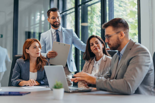 istock Professional team meeting in glass-walled conference room setting 2169204597