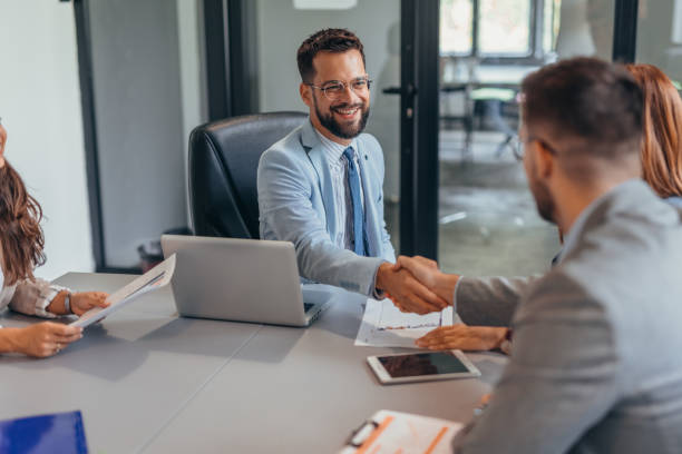 istock Business meeting with handshake between partners in modern office. 2169204611